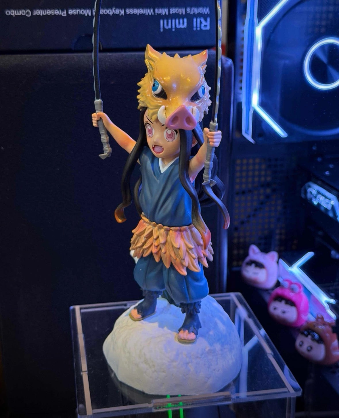 Figurine of a character with long hair and traditional outfit on a reflective surface