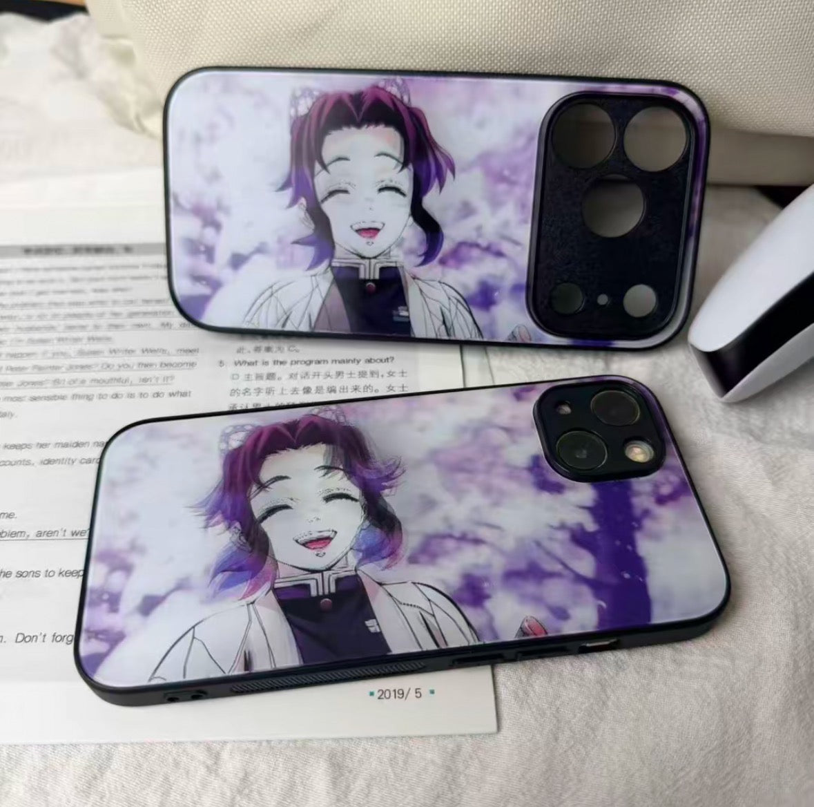 Two phone cases with an anime character design on a surface.