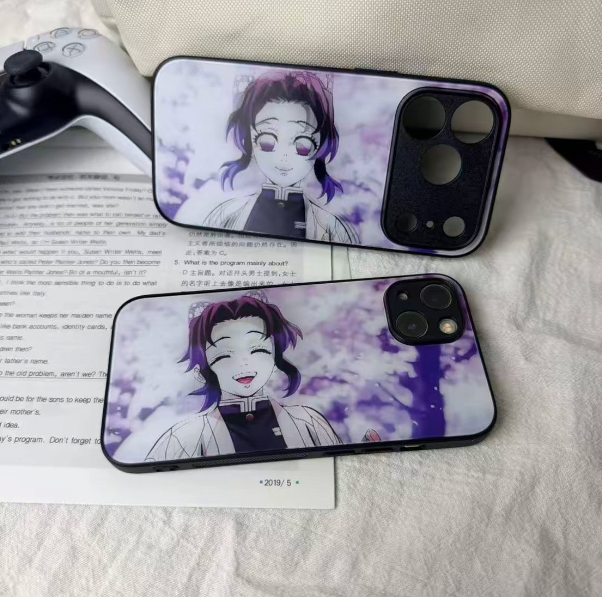 Two phone cases with an anime character design on a textured surface.