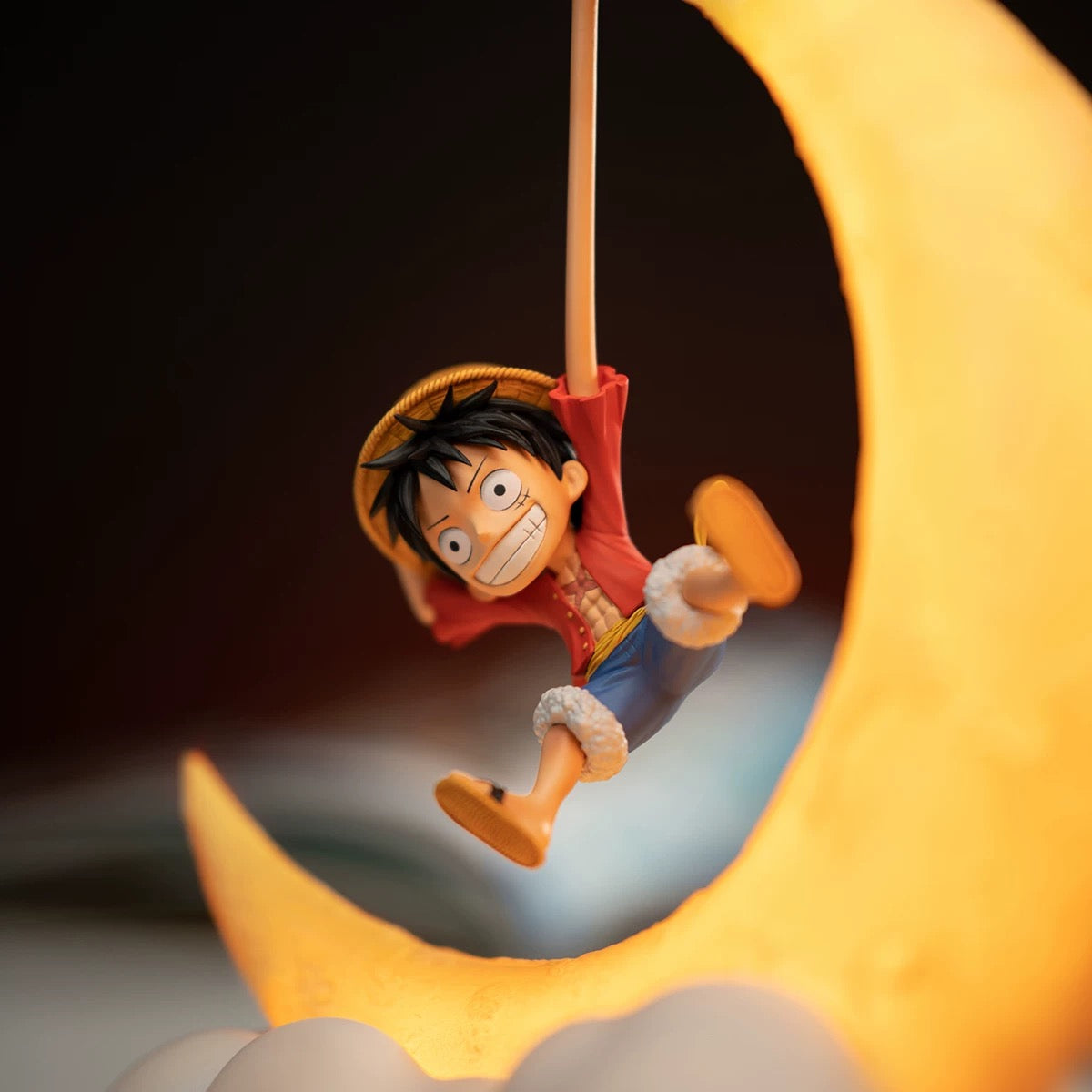 Animated character swinging on a rope with a crescent moon in the background