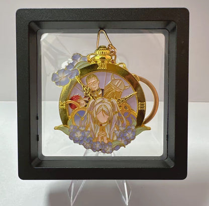 Decorative pendant with intricate design in a black frame on a white background