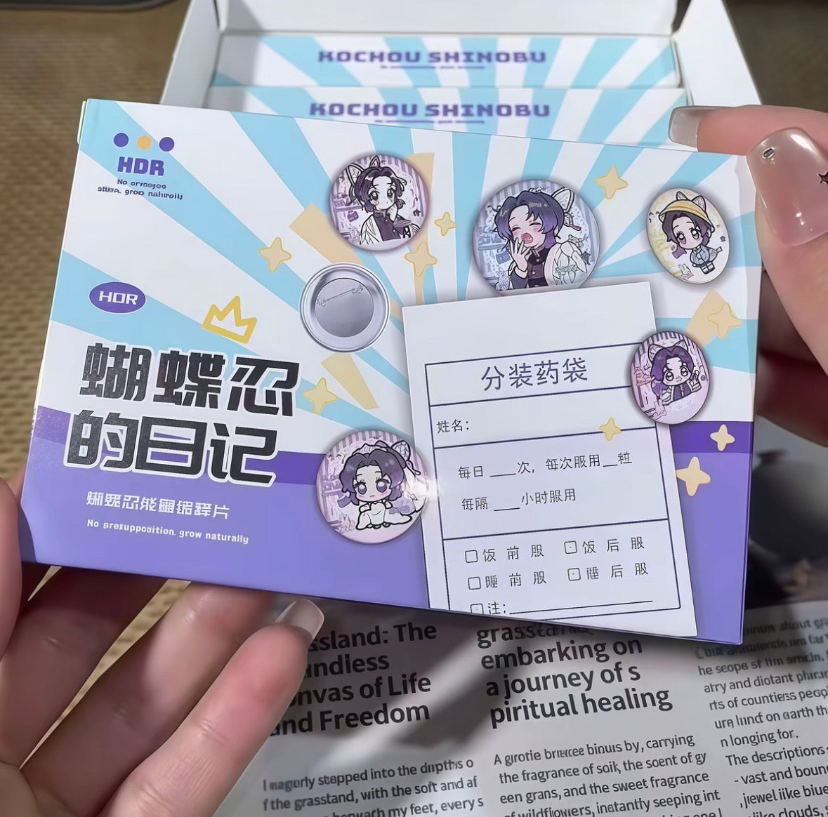 Card with cartoon character and text held by a hand, with a blurred background